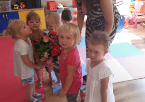 Dzieci wręczają prezent i kwiaty wychowawczyni.