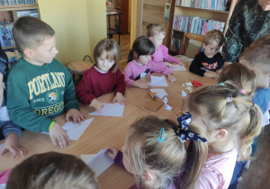 Dzieci składają papier wg instrukcji.